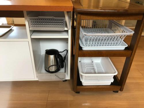 a kitchen cabinet with white shelves and a coffee pot at Villa Chillon - Vacation STAY 97710 in Sakate