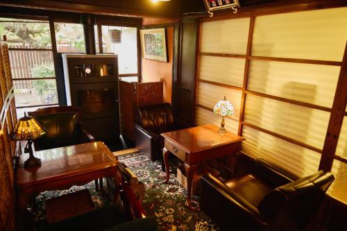 a room with chairs and a table and a desk at Chikugo Yoshii Guest House IKUHA - Vacation STAY 00074v in Ukiha