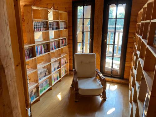 a chair in a library with shelves of books at Ise Forest villa - Vacation STAY 9557 in Ise