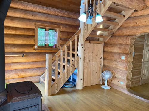 a staircase in a log cabin with wooden walls at Ise Forest villa - Vacation STAY 9557 in Ise