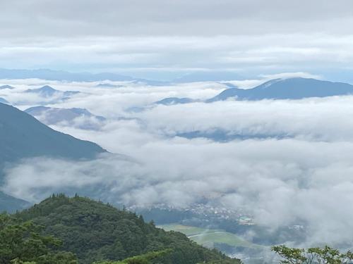 a view of clouds and mountains from the top of a mountain at Ise Forest villa - Vacation STAY 9557 in Ise