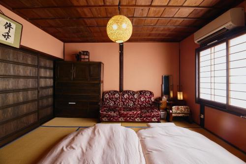 a bedroom with a bed and a chair in it at Chikugo Yoshii Guest House IKUHA - Vacation STAY 00064v in Ukiha