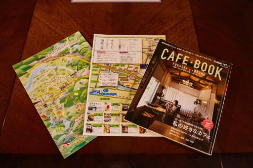 a cafe book sitting on top of a table at Chikugo Yoshii Guest House IKUHA - Vacation STAY 00064v in Ukiha