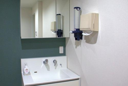 a bathroom with a sink and a mirror at Guest House Orange no Kaze - Vacation STAY 01295v in Imabari