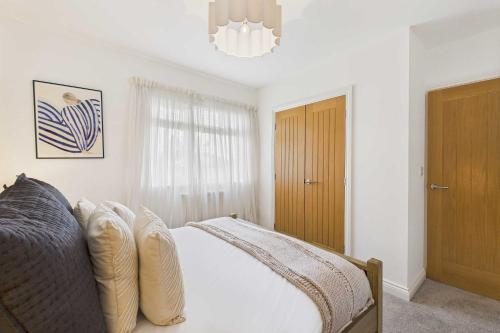a bedroom with a bed and a chandelier at Host & Stay - Bayview Lodge in Beadnell