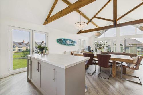 a kitchen and dining room with a table and chairs at Host & Stay - Bayview Lodge in Beadnell