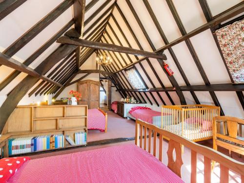 a room with pink beds in a attic at Farmhouse in Beveren near Beach & Garden in Beveren