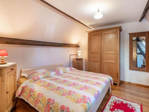 a bedroom with a large bed in a room at Farmhouse in Beveren near Beach & Garden in Beveren