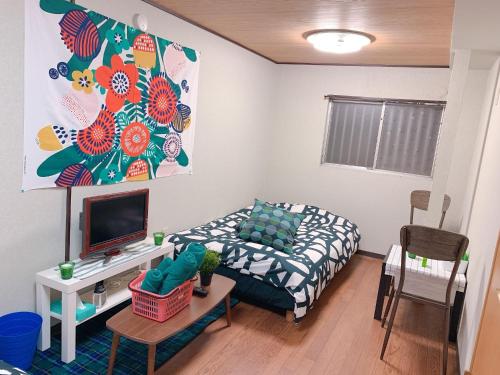 a small living room with a bed and a tv at Osaka - House - Vacation STAY 9690 in Osaka