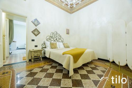 a bedroom with a bed and a checkered floor at Villa Aranci | Historical Residence | By Tilo Lux in Genova