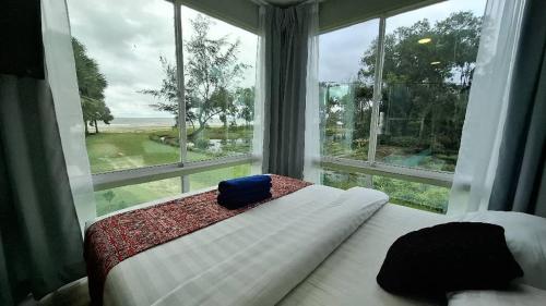 PaparにあるPapar Beachfront Viewのベッドと大きな窓のある寝室