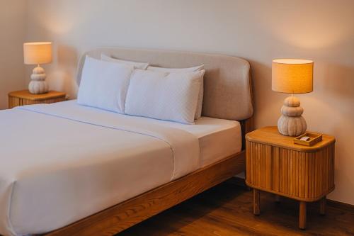 a bedroom with a bed with two lamps on tables at 5BR Villa with Pool & Patio at Casa Eloisa by Bocobay in Oranjestad