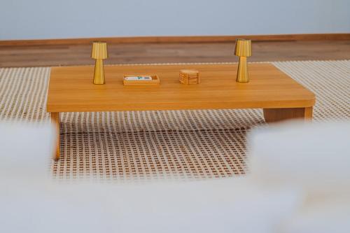a wooden coffee table with two lamps on it at 5BR Villa with Pool & Patio at Casa Eloisa by Bocobay in Oranjestad