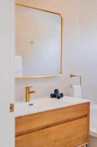 a bathroom with a sink and a mirror at 5BR Villa with Pool & Patio at Casa Eloisa by Bocobay in Oranjestad