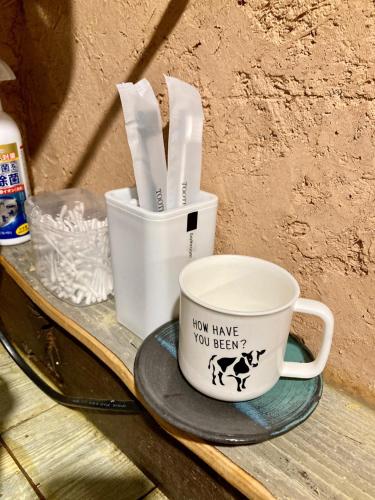 a coffee cup with a sign that says how have you been at Tida House - Vacation STAY 07404v in Koshimizu-shigai