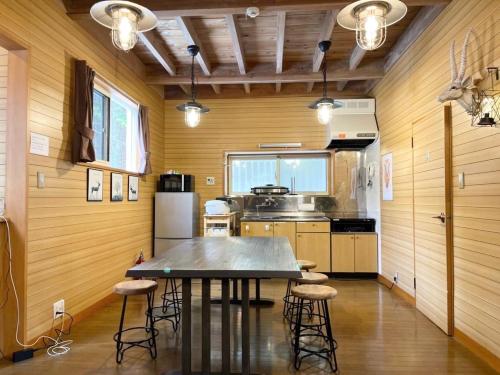 a kitchen with a table and chairs in a room at Shinka Hanare - Vacation STAY 11002v in Oshino