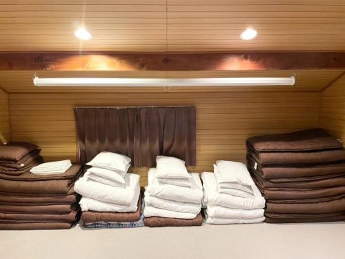 a room with a bunch of pillows and blankets at Shinka Hanare - Vacation STAY 11002v in Oshino