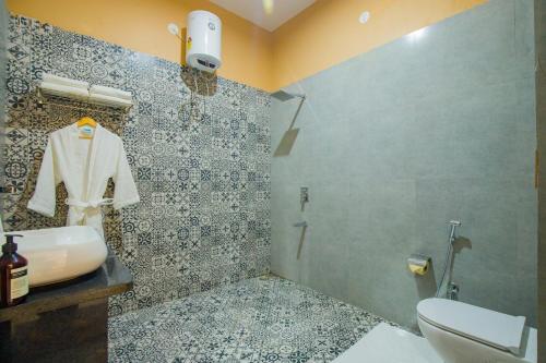 a bathroom with a toilet and a sink and a shower at The Bliss Hushwood 2-BHK Villa With Private Pool, Lush Garden & Poolside Gazebo Pet-friendly in Udaipur