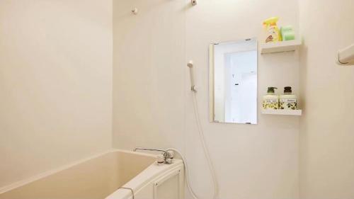 a bathroom with a bath tub and a mirror at Marvelous Higashioi - Vacation STAY 13015v in Tokyo