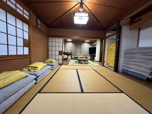 a japanese room with two beds and a living room at Marina and Numazu sweet 1F - Vacation STAY 16710v in Numazu