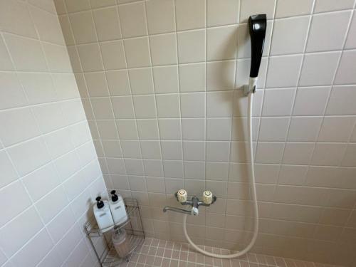 名户NAGO Sakura Resort Inn - Vacation STAY 14447v的浴室内带软管的淋浴