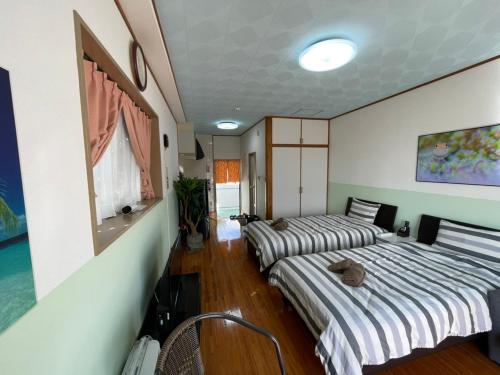 Postel nebo postele na pokoji v ubytování NAGO Sakura Resort Inn - Vacation STAY 14448v