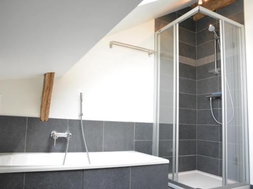 a bathroom with a shower and a bath tub at Beautiful Ardennes house in quiet area in Sainte-Ode