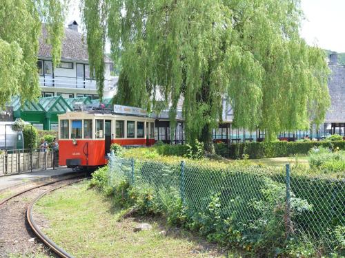 a small train on the tracks near a fence at Beautiful Ardennes house in quiet area in Sainte-Ode
