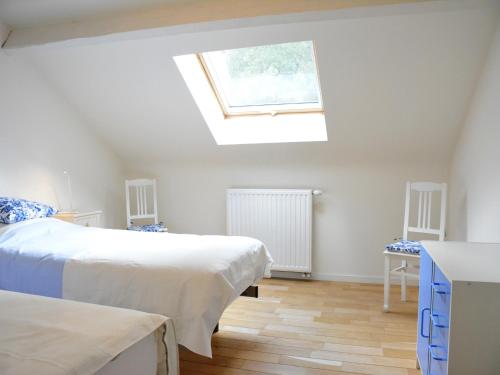 a bedroom with two beds and a skylight at Beautiful Ardennes house in quiet area in Sainte-Ode