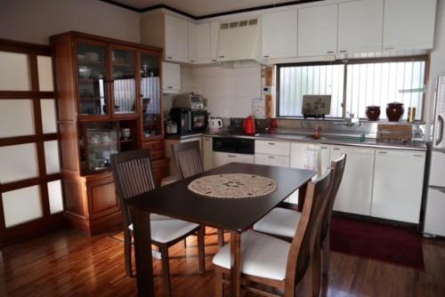 a kitchen with a table and chairs in a room at Oyado Endo - Vacation STAY 12914v in Sanuki