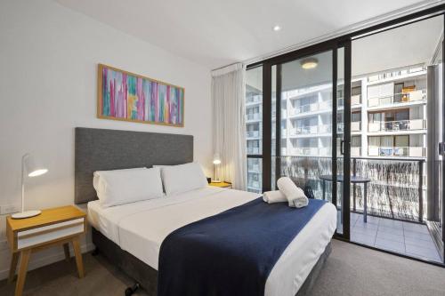a bedroom with a bed and a large window at Broadbeach 806 in Gold Coast