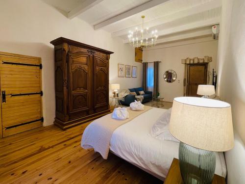 a bedroom with a large bed and a lamp at Les Herbes Blanches - Gîte privé - calme & nature, rivière in Grospierres