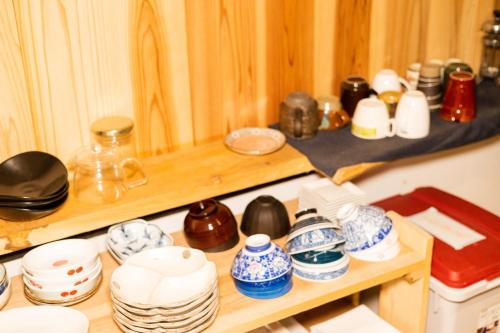 a shelf filled with lots of dishes and bowls at Onjuku ikkyu - Vacation STAY 14021v in Hongu