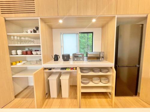 a small kitchen with a refrigerator and a window at Karuizawa House Villa - Vacation STAY 16971v in Oiwake