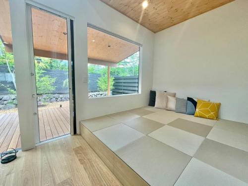 a living room with a large window and a door at Karuizawa House Villa - Vacation STAY 16955v in Oiwake