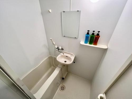 a bathroom with a sink and a bath tub at Hamamoto Palace Taniyama - Vacation STAY 11966 in Kagoshima