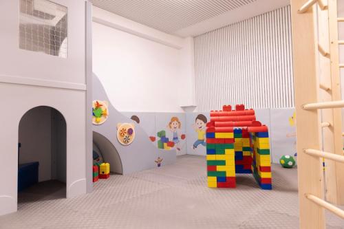 a childs play room with a lego house at Hotel Kirchboden by Alpeffect Hotels in Wagrain