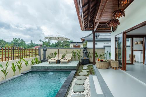a swimming pool in the backyard of a house at Mahayani Ubud Villa in Tegalalang