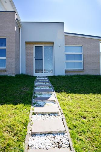 a stepping stone path in front of a house at Gables Box hill Maraylya Two Level House 14ppl in Annangrove