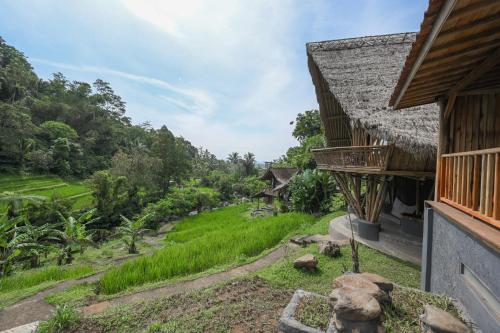 a view from the balcony of a house at Keuma Villa & Resto Jatiluwih by The Lavana in Jatiluwih