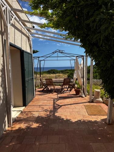 a patio with two chairs and a swing at LocusAmoenus in Plemmirio