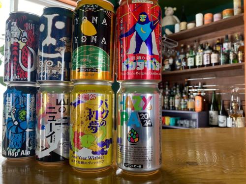four cans of beer sitting on a bar at Maeda Forestry House - Vacation STAY 19184v in Furano