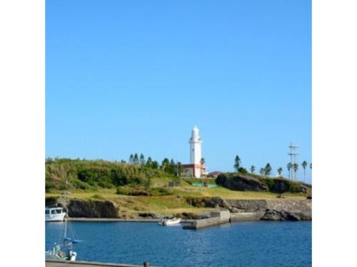 a body of water with a lighthouse in the background at Orizon - Vacation STAY 21783v in Minamiboso