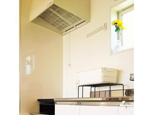 a kitchen with a flower in a vase on the wall at Orizon - Vacation STAY 21783v in Minamiboso