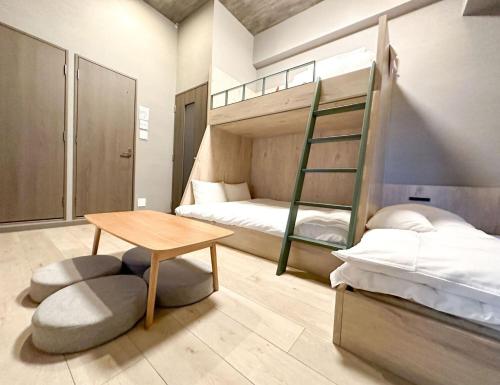 a bedroom with a bunk bed and a table at Rakuten STAY Fukuoka Yakuin Bunk bed Triple Room in Fukuoka