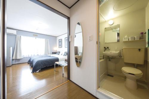 a bedroom with a bed and a toilet and a sink at Flat piece chair house - Vacation STAY 34091v in Fuzuchi