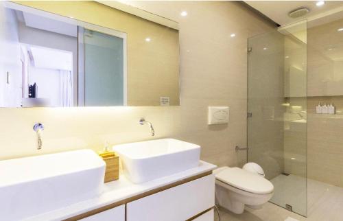 a bathroom with a sink and a toilet and a shower at Diwa Lodge Boracay in Boracay