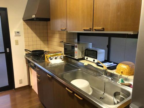 a kitchen with a sink and a counter top at Trust Maison Katase - Vacation STAY 24205v in Izu