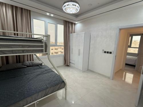 a bedroom with a bunk bed and a large window at new Salalah apartment in Salalah