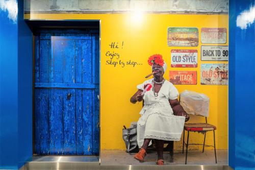 a man sitting on a chair in front of a yellow wall at STEP by STEP - Vacation STAY 25753v in Kanayama